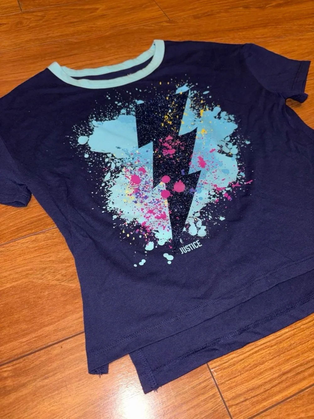 Y2K Justice navy blue tee with white lightning bolt graphic